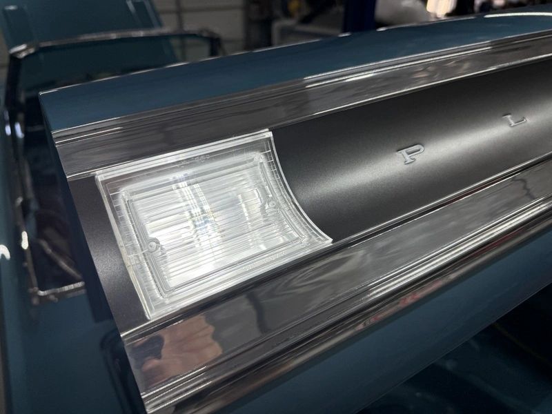 Car tail fin with chrome details.