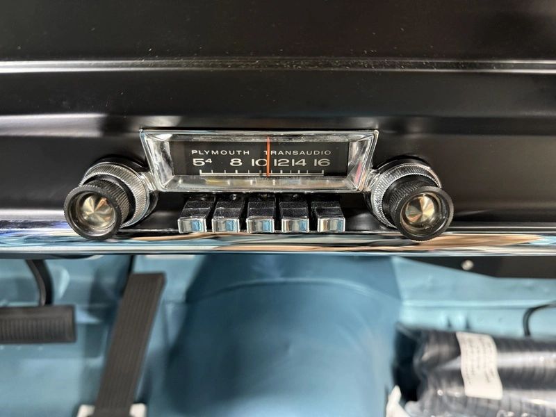 Vintage Plymouth car radio dashboard close-up.