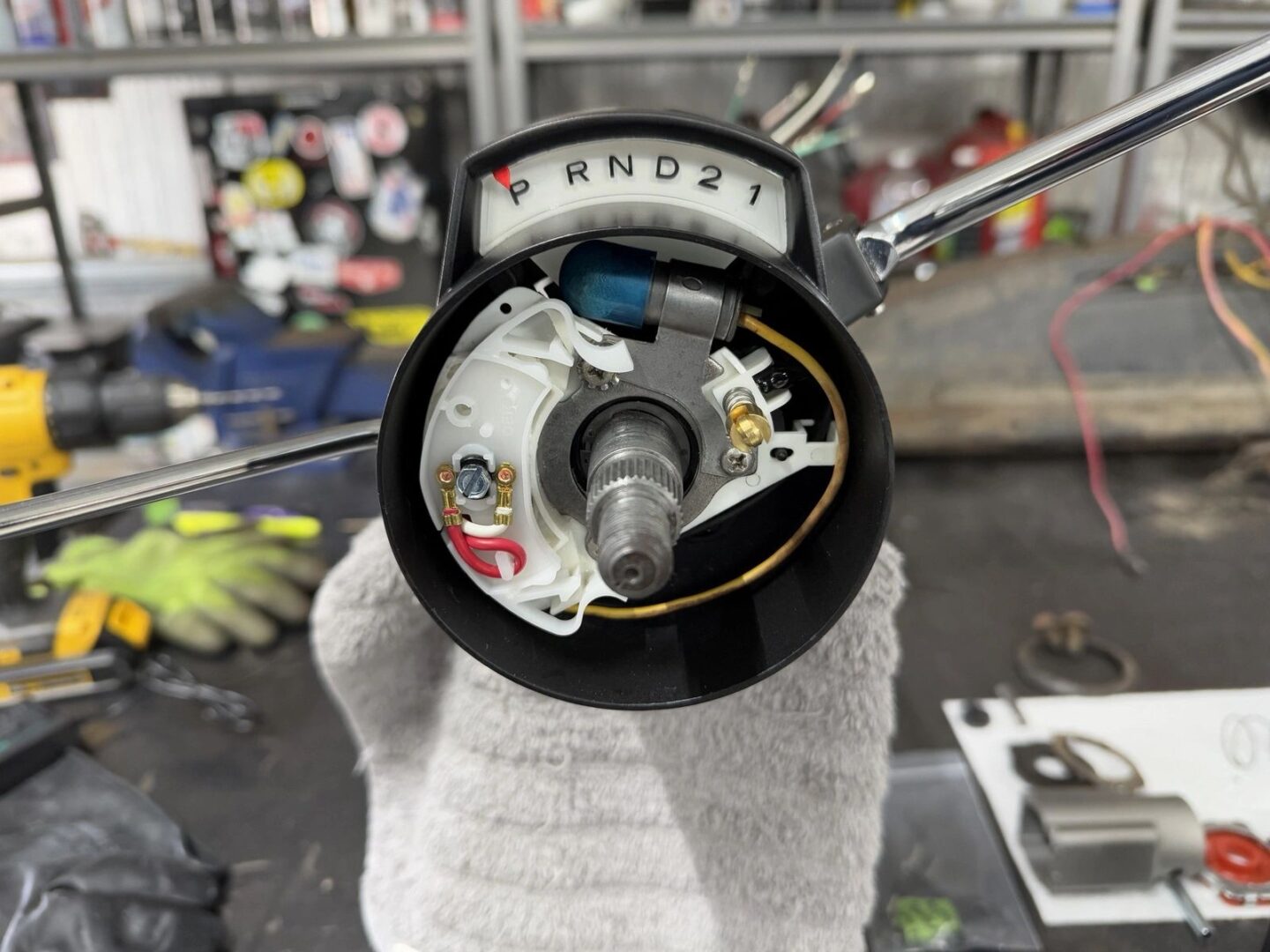 Car gear shift mechanism on workbench.