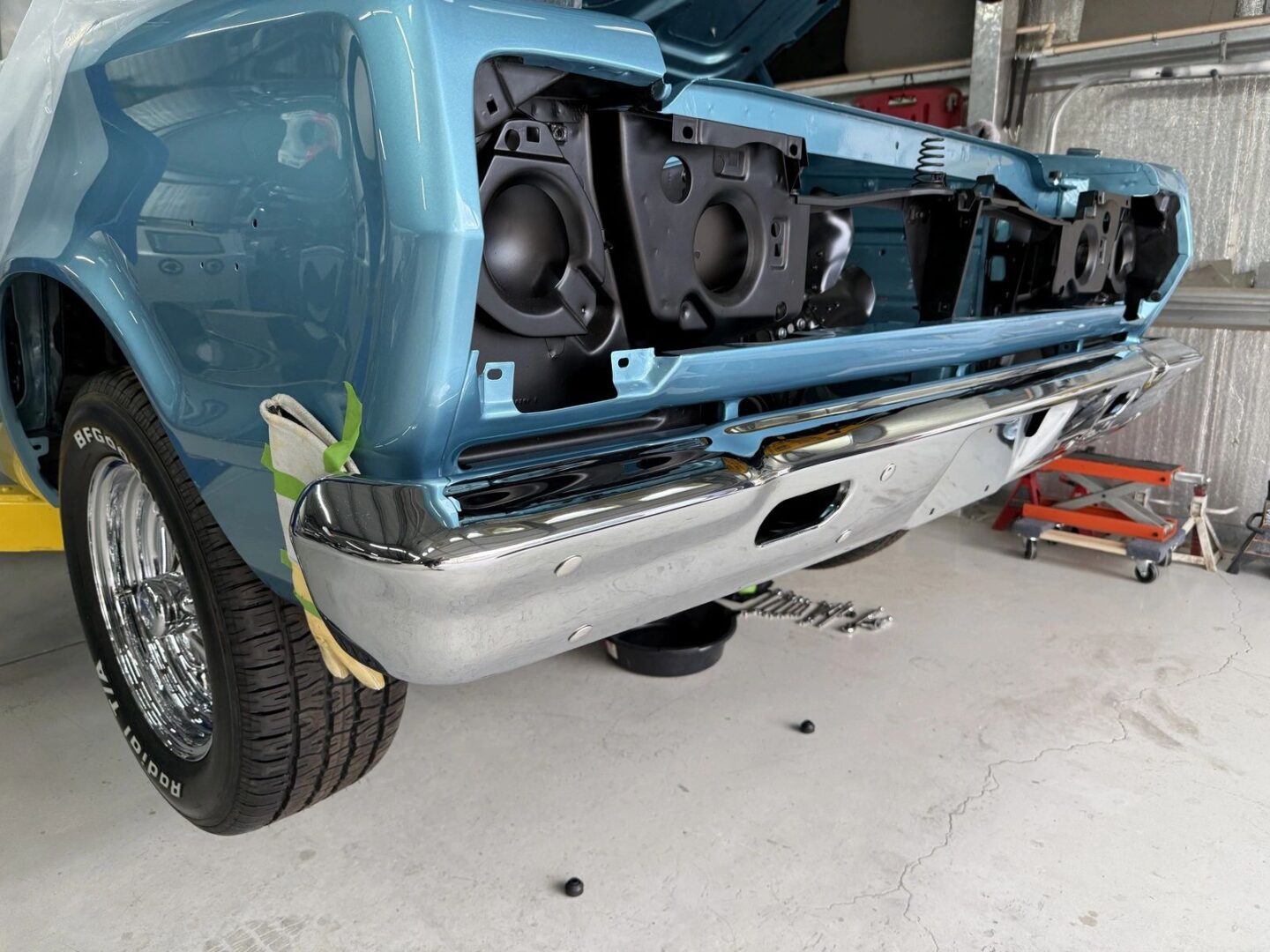 Classic car under restoration in garage.