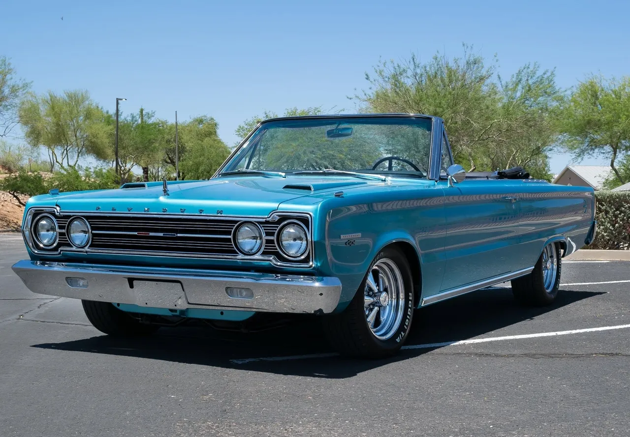 Blue vintage convertible car parked outside.
