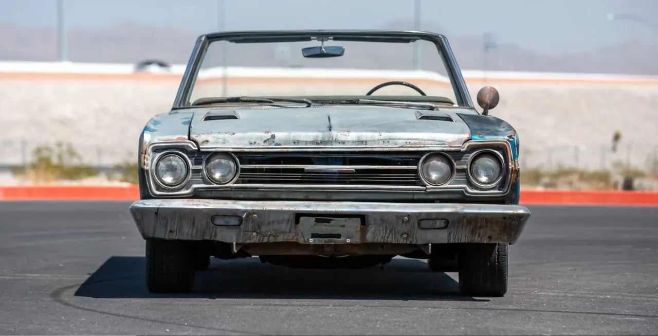 Vintage convertible car on asphalt road.