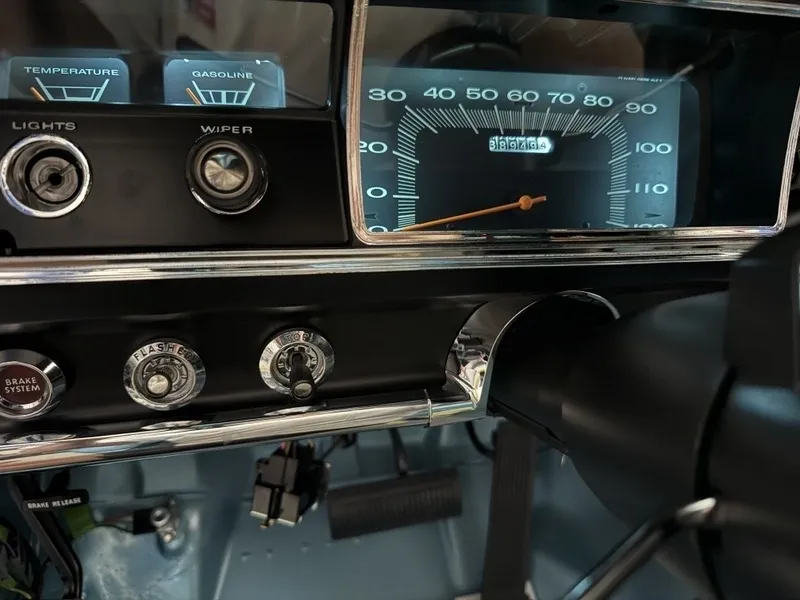 Vintage car dashboard with speedometer and controls.