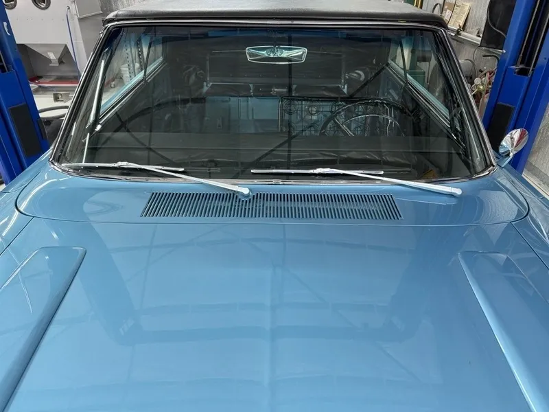 Blue vintage car with front windshield view.
