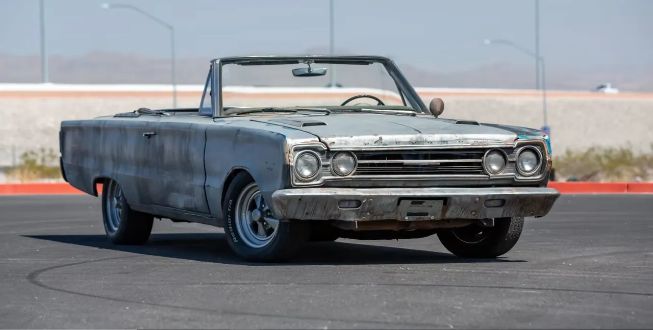 Classic convertible car on an empty road.