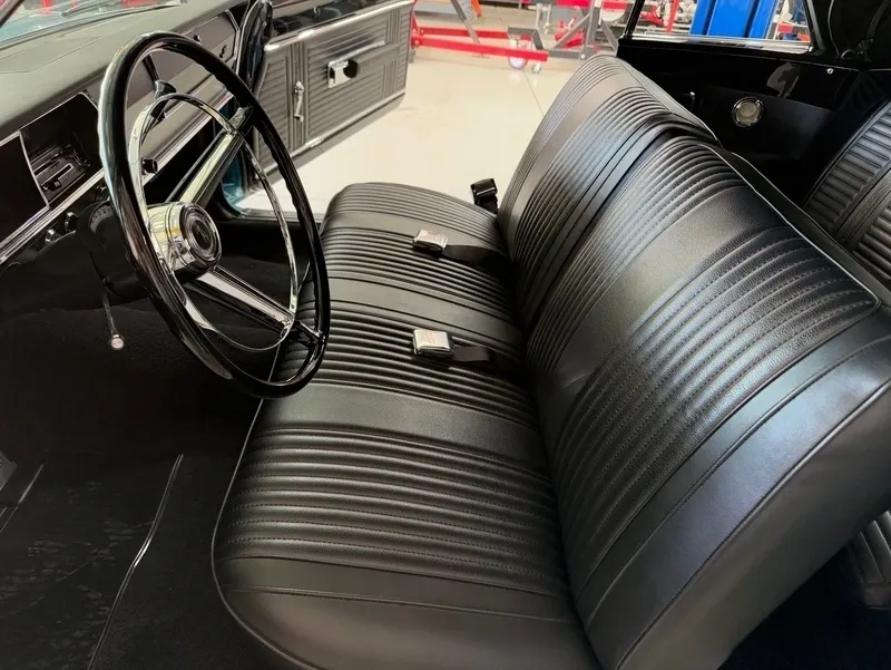 Vintage car interior with black leather seats.
