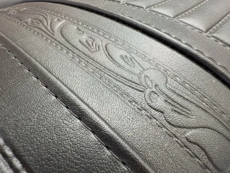 Embossed leather with decorative pattern design.