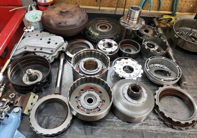 Assorted mechanical parts on a workshop table.