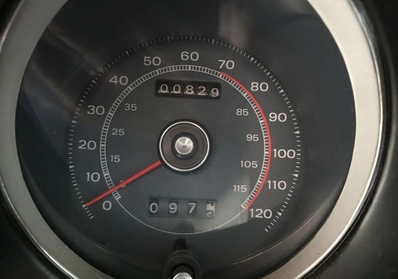 Classic car speedometer showing low mileage.