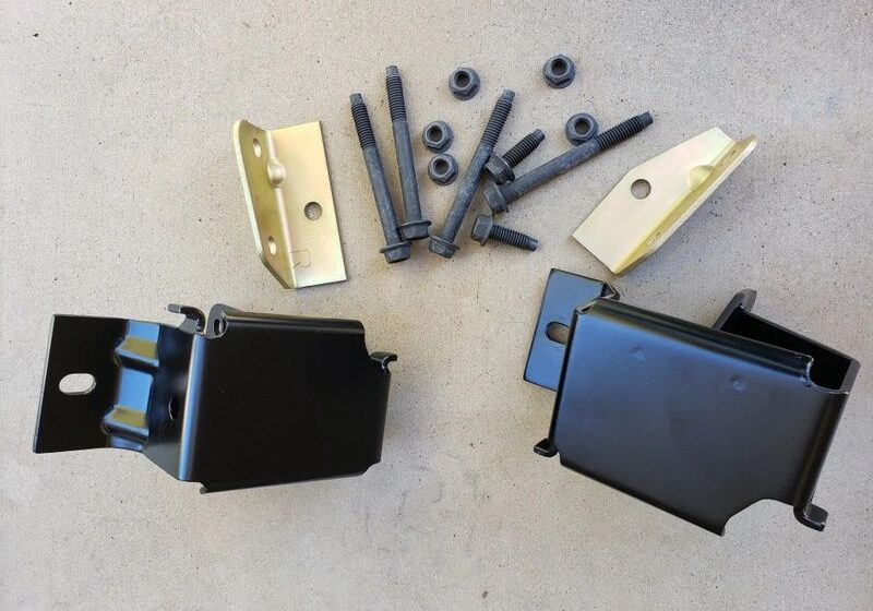 Metal brackets and bolts on beige surface.