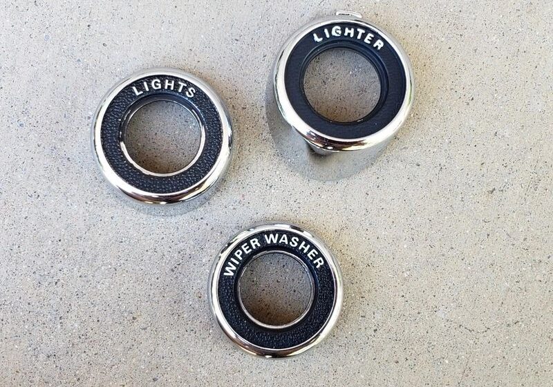 Three vintage car dashboard knob surrounds.