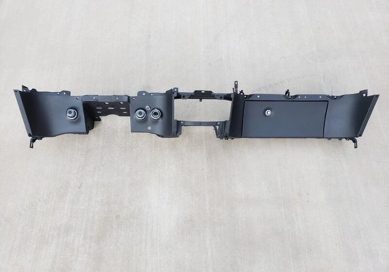 Vehicle dashboard panel on beige background.