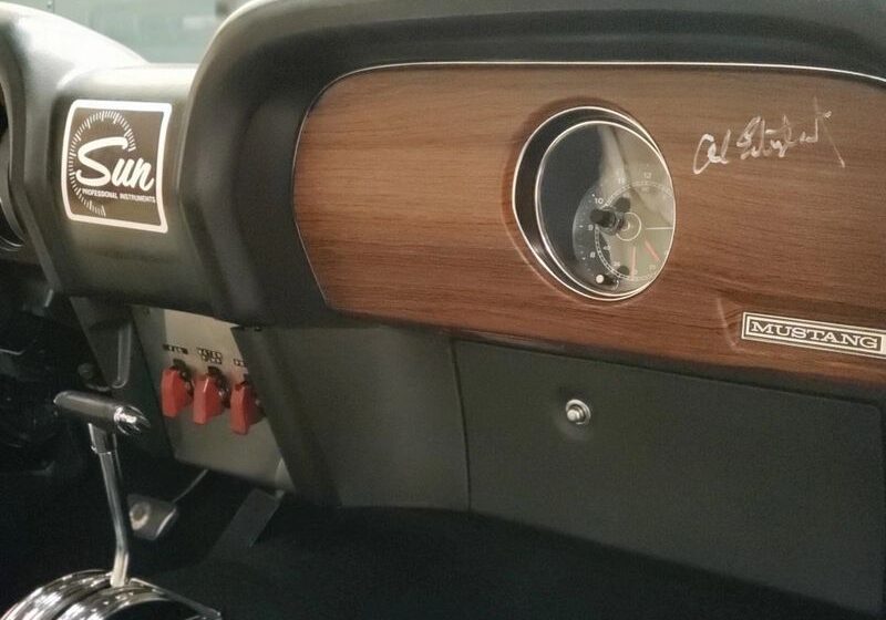 Vintage Mustang dashboard with wooden panel.