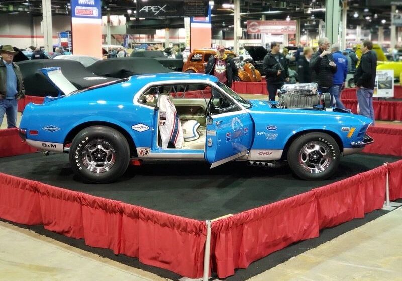 Blue classic car on display at show.