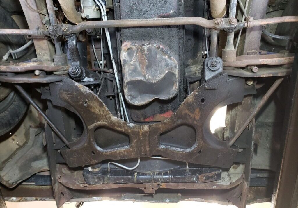 Car undercarriage showing suspension and exhaust system.