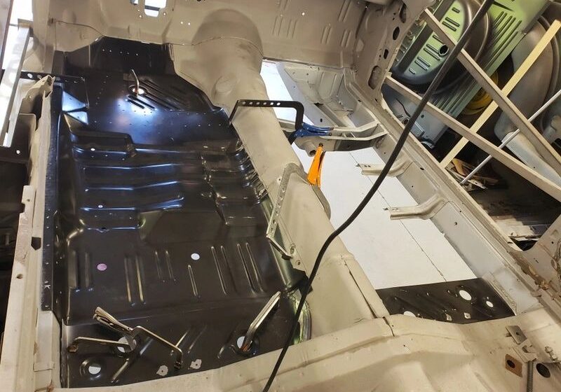 Car interior with exposed metal floor.