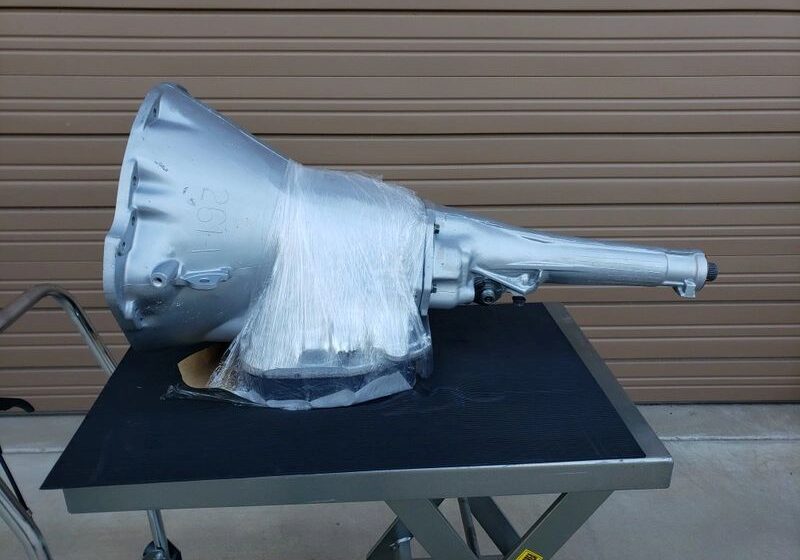 Transmission wrapped in plastic on a cart.