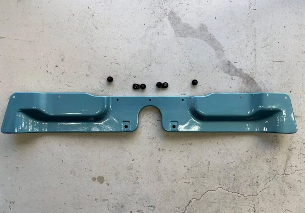 Blue metal car part on concrete floor.