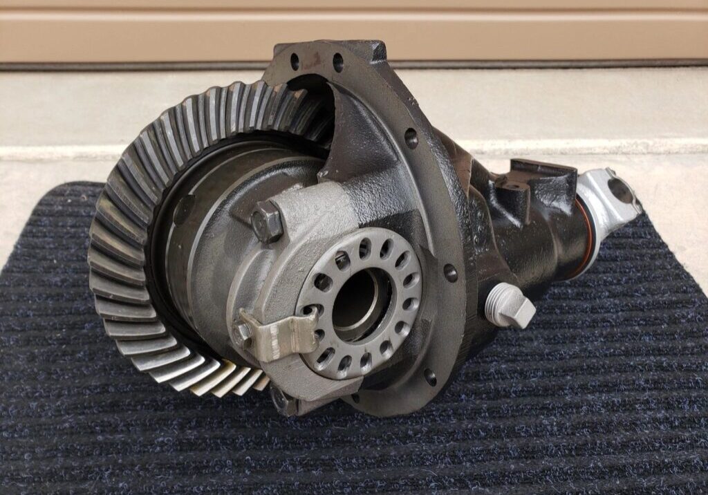 Automotive differential on a black mat.