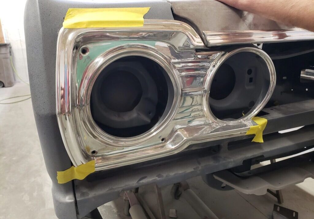 Car headlight frame with yellow tape.