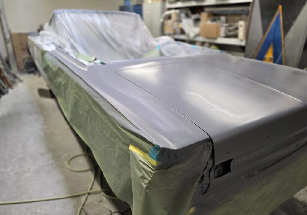 Car undergoing restoration in a workshop.