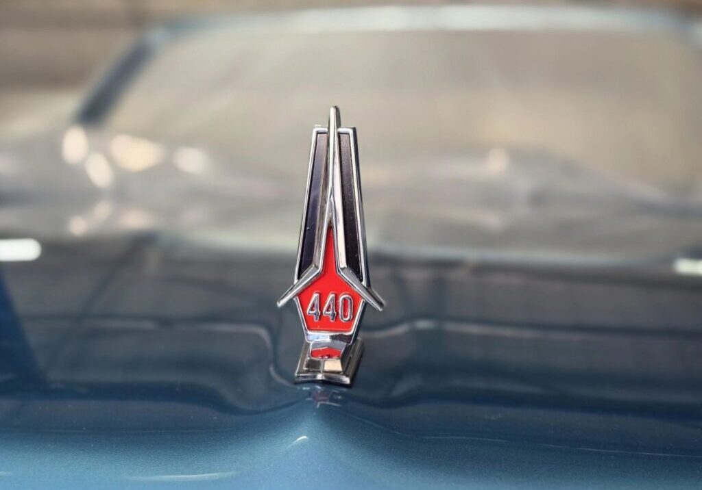 Car hood ornament with "440" emblem.