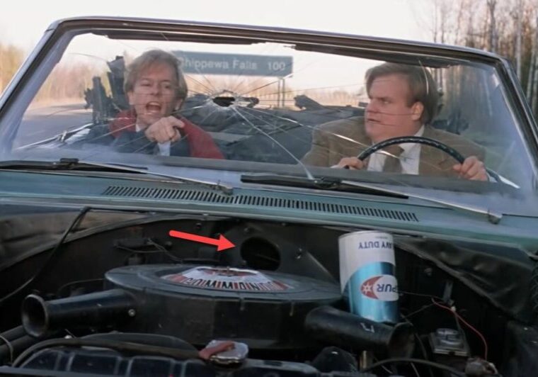 Two men driving a roofless car.