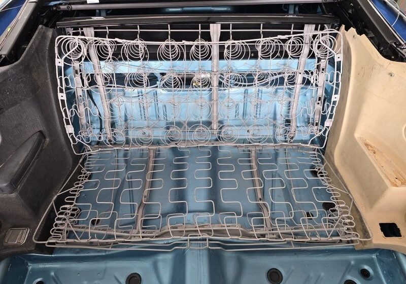 Car trunk with exposed seat springs.