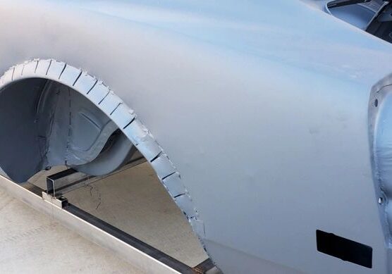 Car body with gray primer coating.