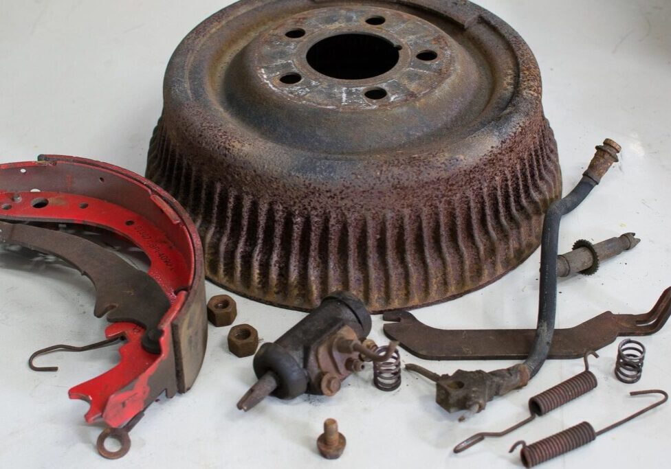 Rusty brake drum with disassembled parts.