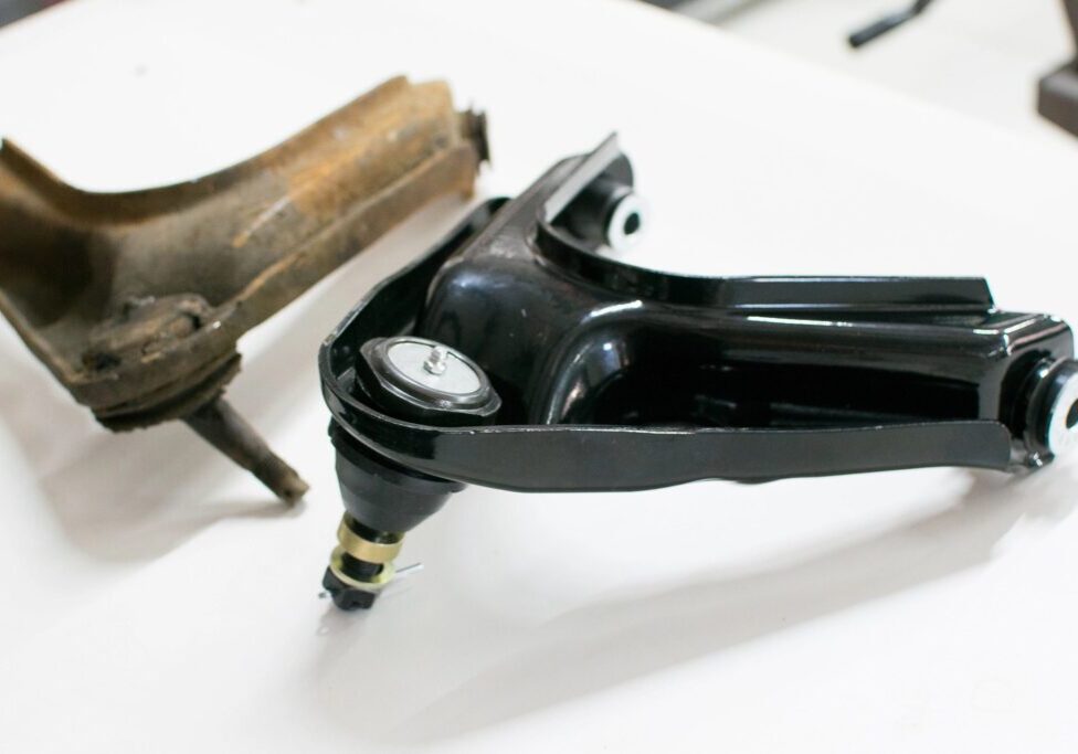 New and old car control arms.