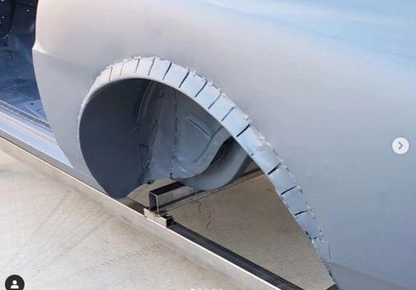 Car fender with cutout and slits.