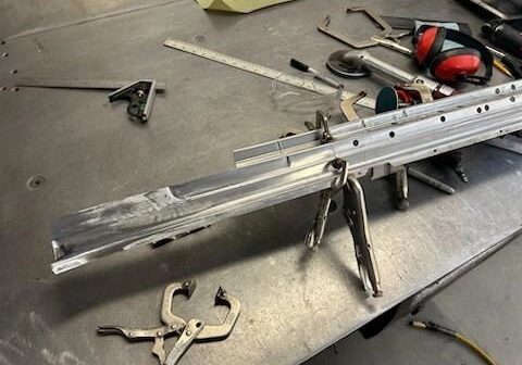 Metalwork table with tools and clamps.