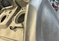 Metal machinery parts in a workshop setting.