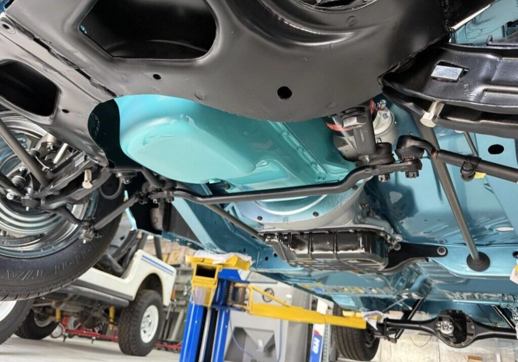 Vehicle undercarriage on a hydraulic lift.