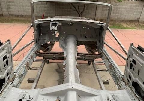 Car chassis under restoration, missing components.