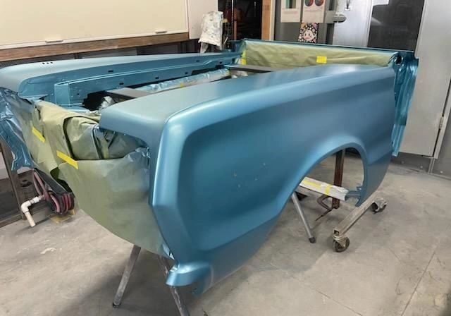 Blue car body in a workshop.