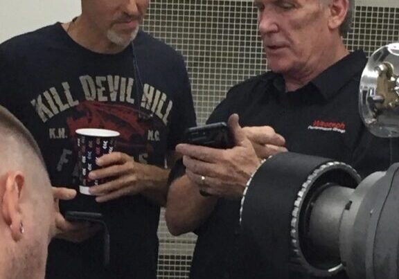 Two men looking at a smartphone.