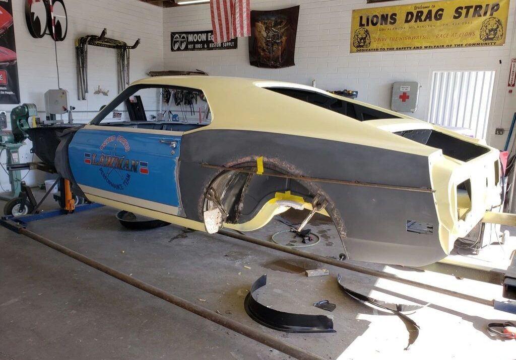 Classic car under restoration in garage.