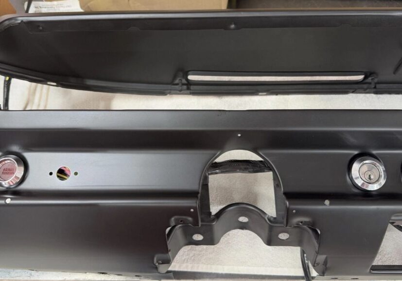 Black car dashboard with button openings.