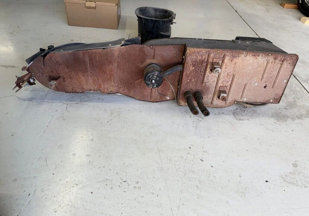 Rusty metal part on garage floor.