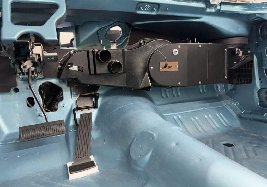 Disassembled car interior with exposed dashboard components.