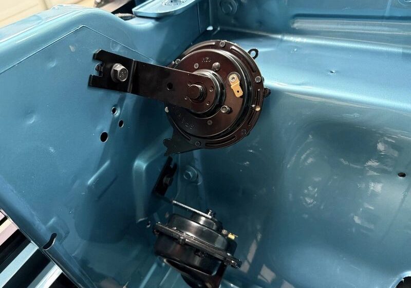 Car engine bay with mounted components.