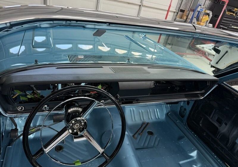 Classic car interior with steering wheel.