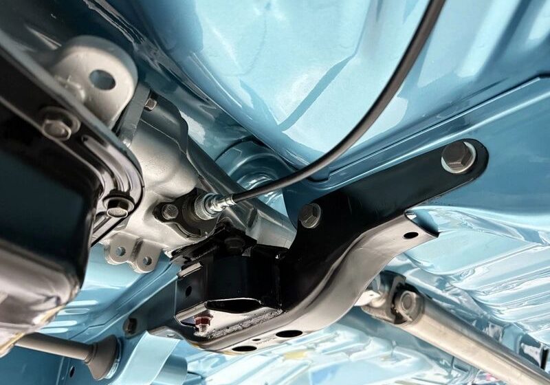 Underside view of a car's chassis components.