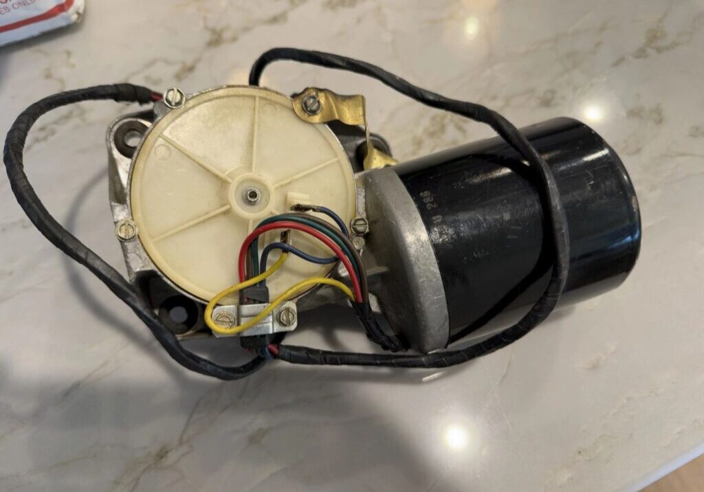Electric motor with wires on marble surface.