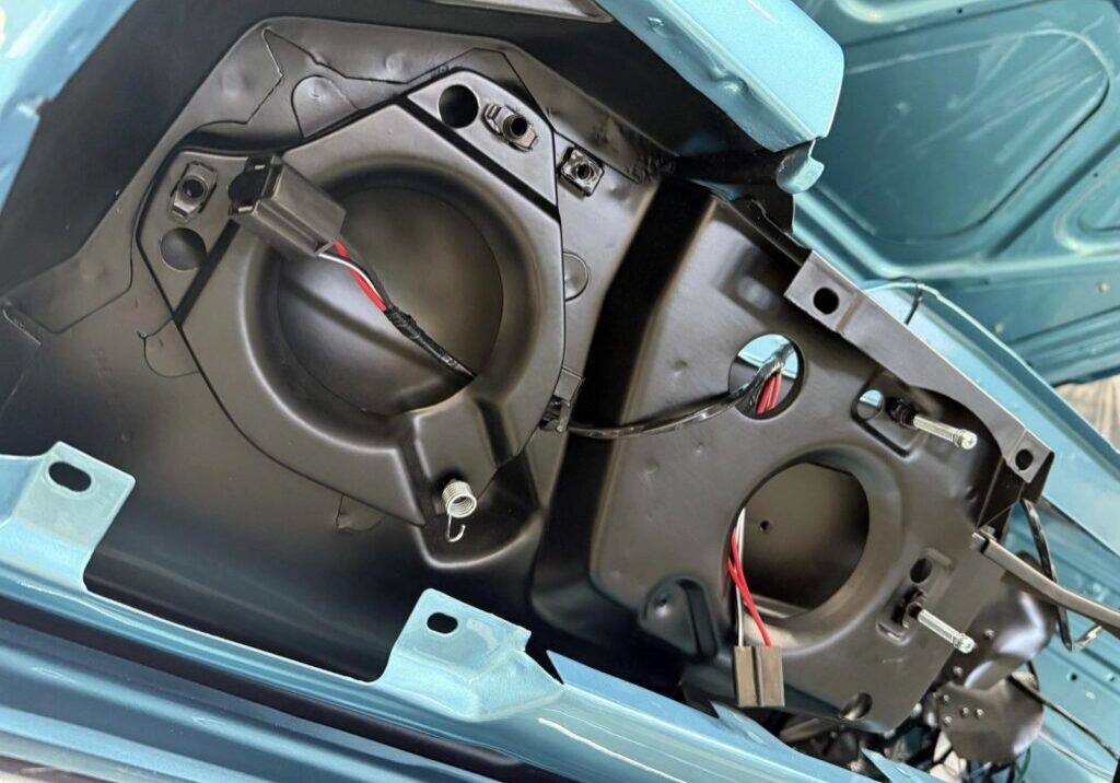 Car trunk interior with wiring visible.