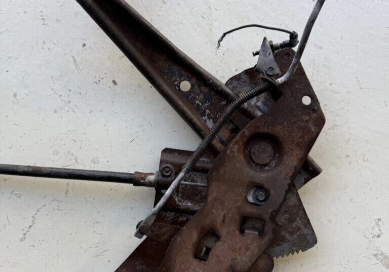 Old rusty mechanical lever on white background.