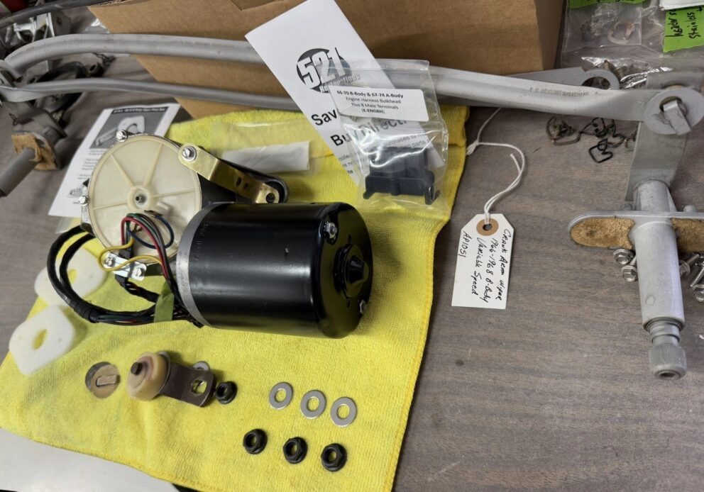 Car window motor parts on yellow cloth.