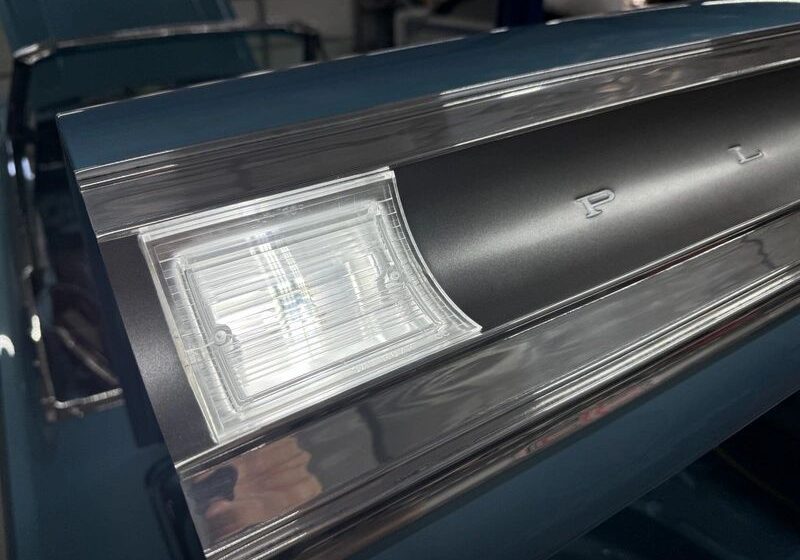 Car tail fin with chrome details.